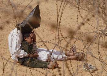 Jean-Marc Bouju France, The Associated Press Iraqi man comforts his son at a holding center for prisoners of war, An Najaf, Iraq, 31 March